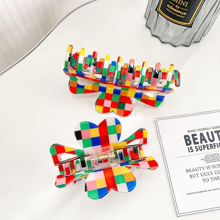 Two vibrant, checkered pattern hair clips showcased against a white background.