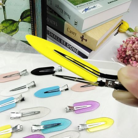 A demonstration of how to use the colorful creaseless flat hair clips.