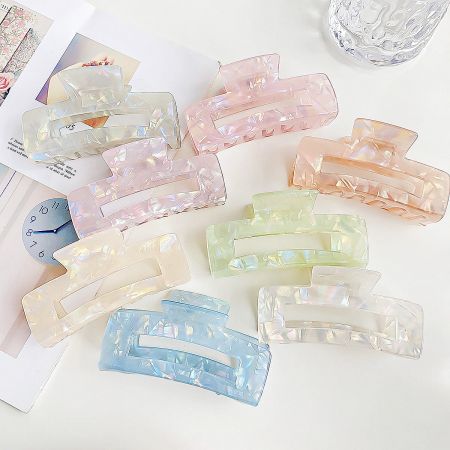 Wholesale Colorful Acetate Big Claw Hair Clips - A vibrant collection of wholesale colorful acetate big claw hair clips in various shades, neatly arranged for display.