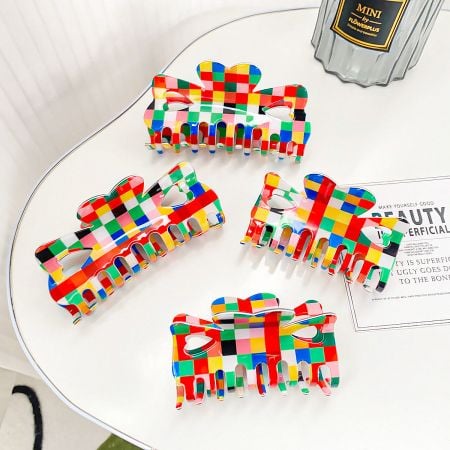 A collection of colorful checkered hair clips arranged neatly on a table for display.