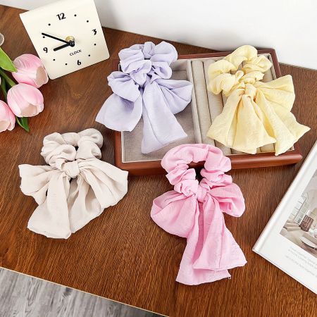 A collection of colorful scrunchies displayed on a wooden surface.