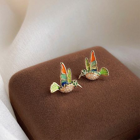 A pair of colorful hummingbird enamel earrings with gold plating, showcasing intricate details.