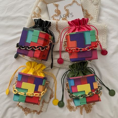 Four colorful patchwork bags with gold accents, showcasing different color variations of the crossbody bag.
