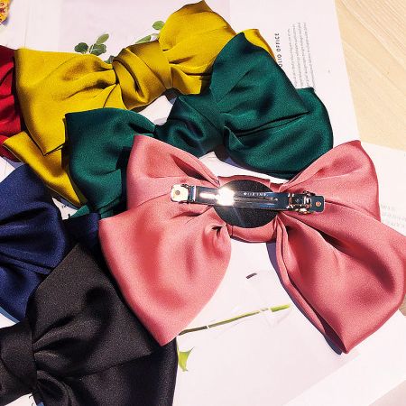 An assortment of colorful satin hair bows, perfect for wholesale collections.