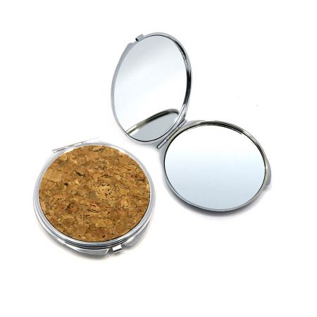 Interior view of the cork compact mirror showing the dual-sided regular and 2X magnifying mirrors.