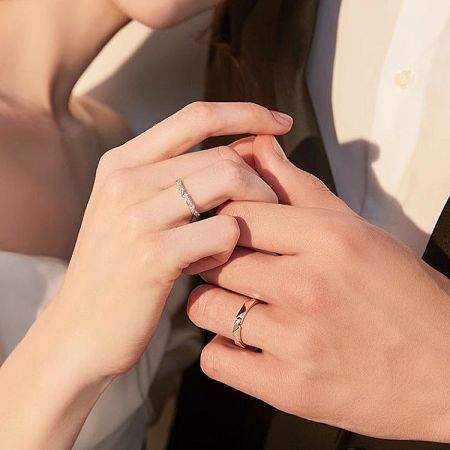 925 Sterling Silver Origami-Inspired Couple Rings Set - A couple wearing the matching 925 sterling silver origami-inspired rings, showcasing the geometric design on their hands.