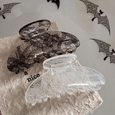 Black and clear jacquard patterned hair clips displayed on a neutral background.