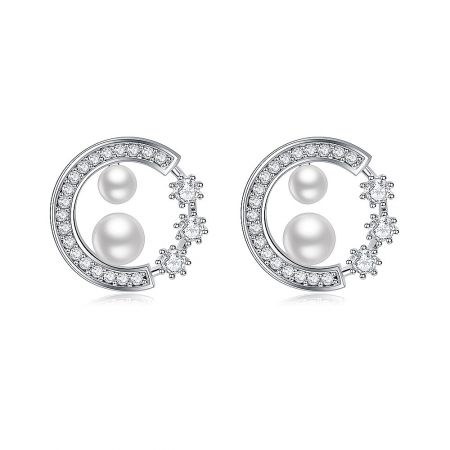 Enticing Pearl Studs - A pair of Enticing Pearl Stud earrings in a crescent moon design, featuring white cubic zirconia and pearls, displayed on a clean white background.