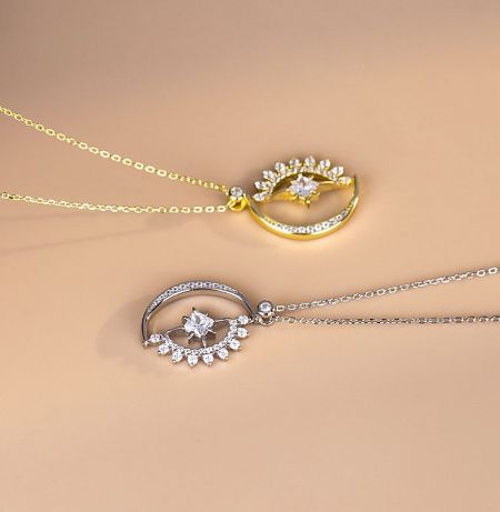 Close-up detail of the crescent moon and star pendant, highlighting the intricate pave setting of the white cubic zirconia stones.