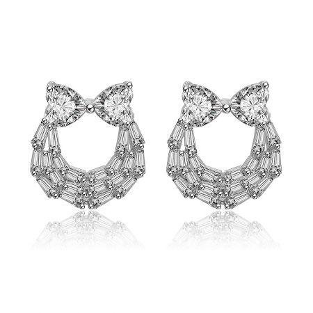 Two Hearts And Baguette Earrings - Front view of the Two Hearts And Baguette Earrings, showcasing the rhodium-plated brass setting with a heart-shaped cubic zirconia and a bow-like crystal frame.