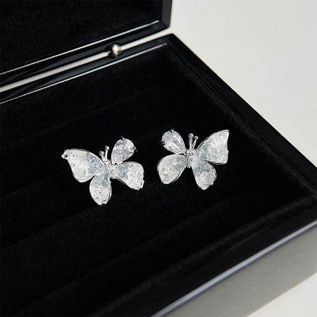 The set of crystal butterfly earrings elegantly presented in a black velvet jewelry box, perfect for gifting or retail display.
