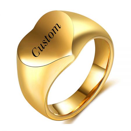 Detailed view of a custom gold ring with a heart motif