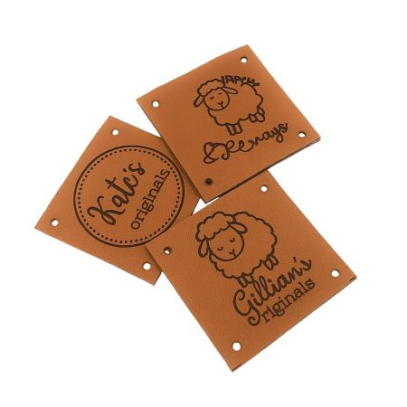 Examples of custom leather tags with intricate laser-engraved designs and text.