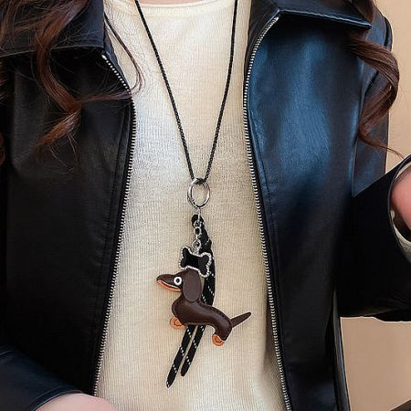 Close-up of a charming dachshund pendant brass necklace.