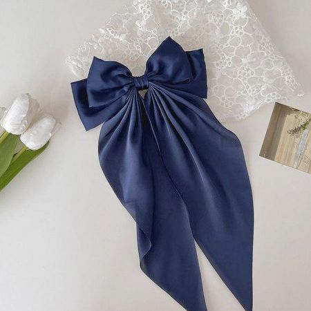 A sophisticated dark blue satin long-tail bow hair clip.