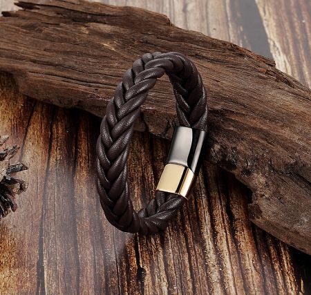A dark brown braided leather bracelet with a sleek gold-tone stainless steel clasp, showcasing an alternative color option.