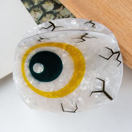 Detailed view of a yellow Evil Eye hair clip.