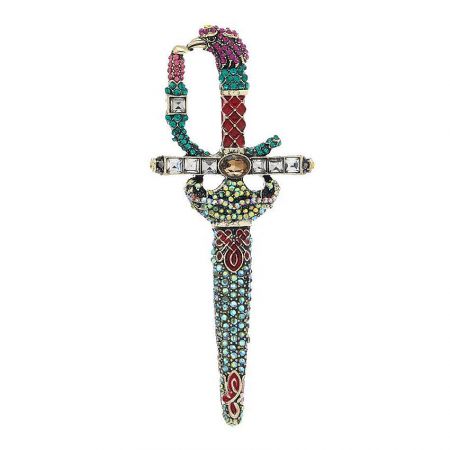 Detailed shot of the decorative sword brooch's hilt, adorned with colorful gemstones.