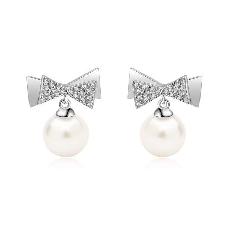 Bow 7mm Pearl Drop Earrings - A close-up of the Bow 7mm Pearl Drop Earrings, showcasing the intricate diamond-encrusted bow design and the lustrous white freshwater pearl.