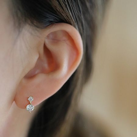 Close-up view of the mini crystal huggies hoop earrings being worn, showcasing their sparkle.