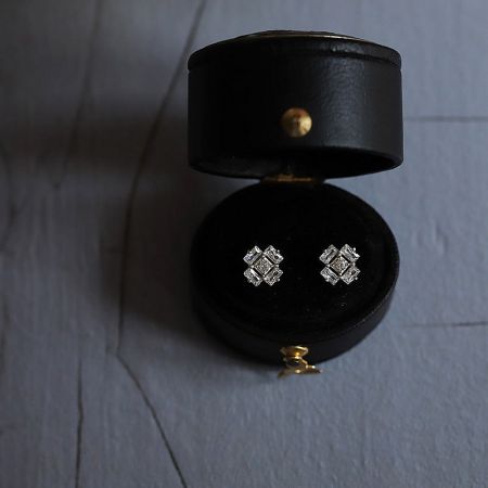 The sterling silver ice cube earrings presented in a luxurious black leather jewelry box.