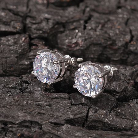 Side view of the Round Moissanite Solarite Earrings in a silver finish, displayed on a dark wood surface.