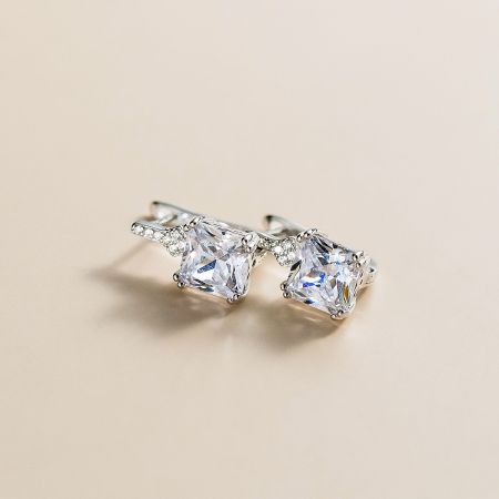 Close-up of a sterling silver stud earring with a large clear CZ gemstone.