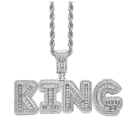 Detailed view of a silver 'KING' pendant necklace fully encrusted with sparkling diamonds.
