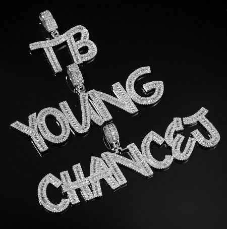 Custom Iced Out Pendant - A custom iced out pendant featuring the words 'TB YOUNG CHANCE' fully encrusted with sparkling diamonds, showcasing JR Fashion's hip hop jewelry craftsmanship.