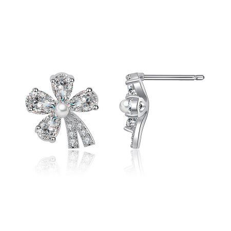 A detailed view of the diamond and pearl flower-shaped earrings, showcasing the sparkling cubic zirconia petals.