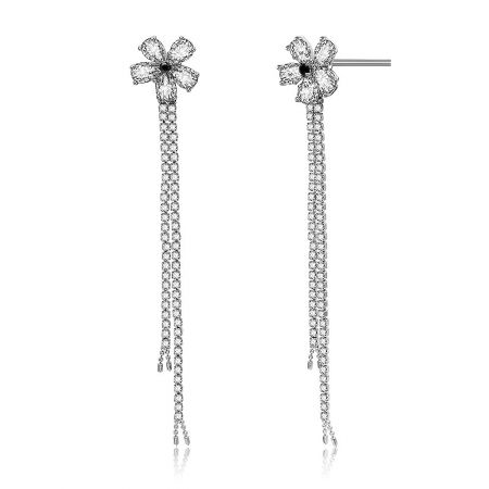 Detailed close-up of the cubic zirconia flower design and dangling chains on the chandelier earrings.