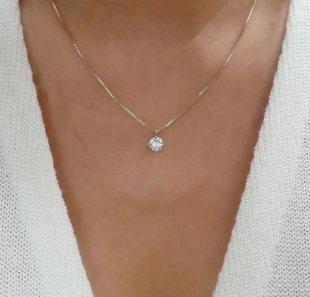A model wearing the 925 Sterling Silver Solitaire Pendant Necklace to showcase its length and appearance.