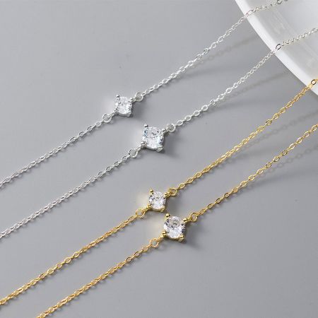 925 Sterling Silver Single Zircon Bracelet - A collection of 925 sterling silver single rhinestone bracelets, displayed in both gold and silver finishes and two different stone sizes.