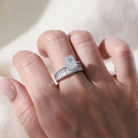 Angled product shot of the white gold tone radiant-cut CZ engagement ring on a neutral background.