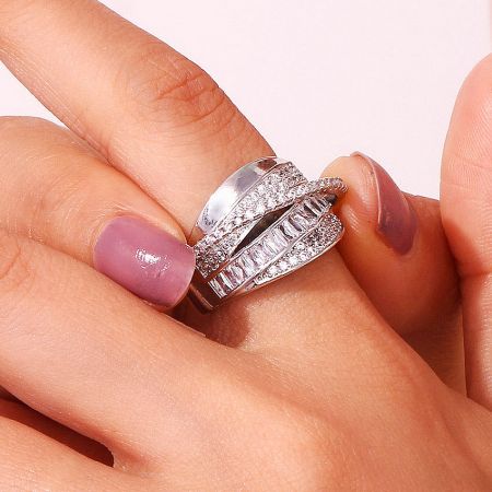 A close-up of the set of five adjustable brass rings, showcasing their brilliant sparkle.