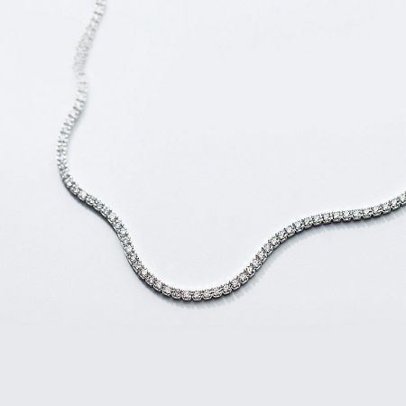 A beautifully crafted 925 sterling silver tennis chain choker necklace with sparkling zircons, displayed on a clean white surface.