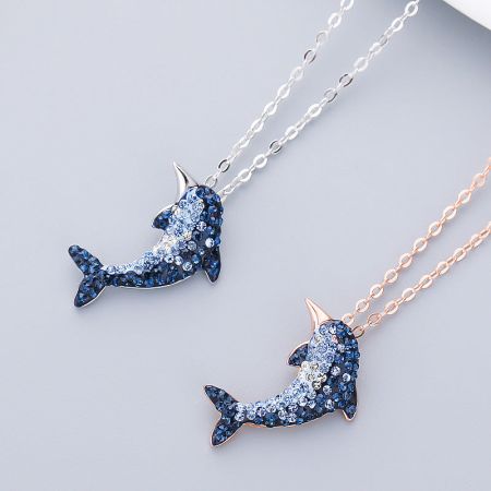 Both silver and rose gold versions of the 925 sterling silver dolphin necklace with gemstones.
