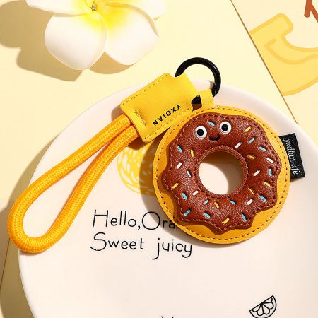 Detailed view of the cute donut-themed keychain with pink frosting and colorful sprinkles.