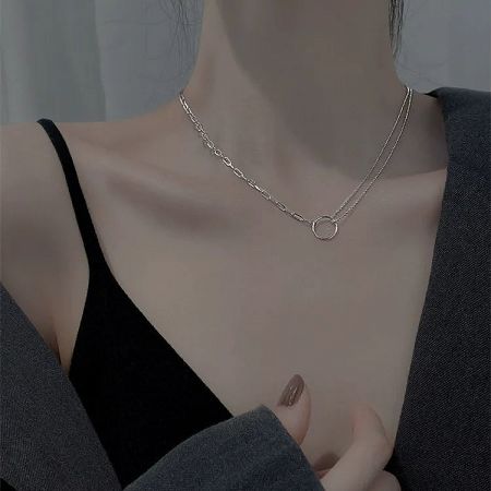 Angled product view of the double-layered silver necklace, highlighting its modern design.