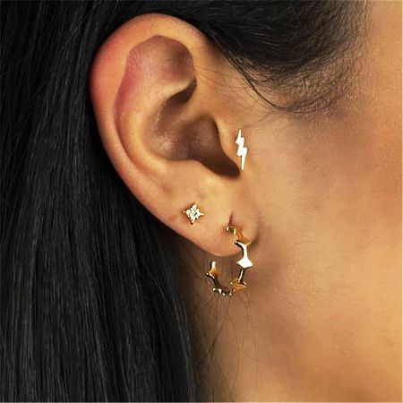 A collection of various stud earrings including stars and lightning bolts.