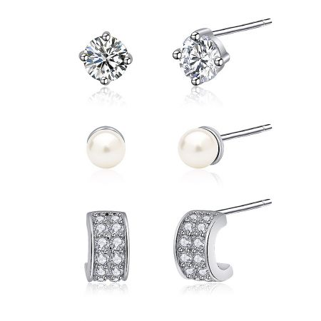 A collection of three pairs of earrings: sparkling cubic zirconia studs, classic pearl earrings, and elegant CZ hoop earrings.