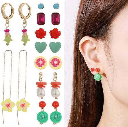 An assortment of colorful earring designs from the collection, including star, flower, and heart shapes.