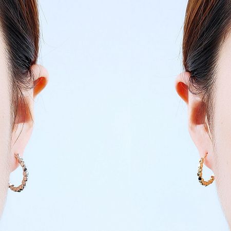 A model showcasing two different styles of the beaded hoop earrings.