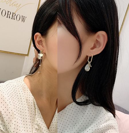 Model wearing the Dainty Geometric Resin Earrings to demonstrate their size and how they complement an outfit.