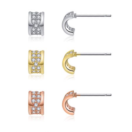 A top-down view of the three pairs of Mini Curved Pave Earrings, highlighting their three-tone metal finishes.