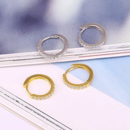 Product showcase of the micro-inlaid zircon hoop earrings in both 925 sterling silver and gold finishes.