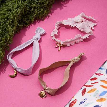 Coquette Style Ribbon Bracelets Set of 5 in Gold Stainless Steel - Wholesale set of coquette style ribbon bracelets with gold stainless steel sun, moon, and bow charms, perfect for fashion jewelry retailers.