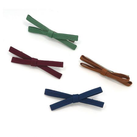 Top-down view of the four fabric hair bows in green, maroon, brown, and navy blue.