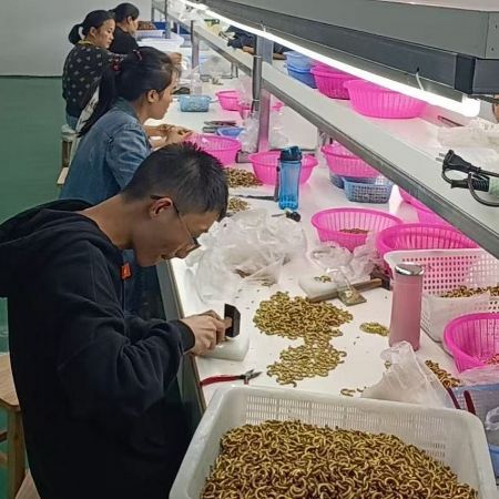 A close-up view of detailed work on chain links, highlighting the precision and care in our environmentally conscious manufacturing process.