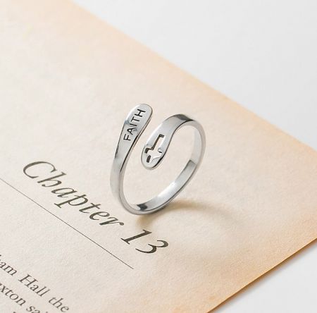 925 Sterling Silver Faith Cross Ring - A 925 sterling silver ring engraved with the word 'FAITH' and a cross symbol, resting on an open book to showcase its inspirational design.